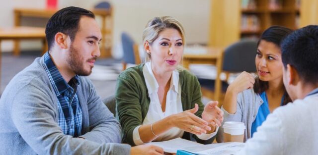 a group of teachers sitting at a table