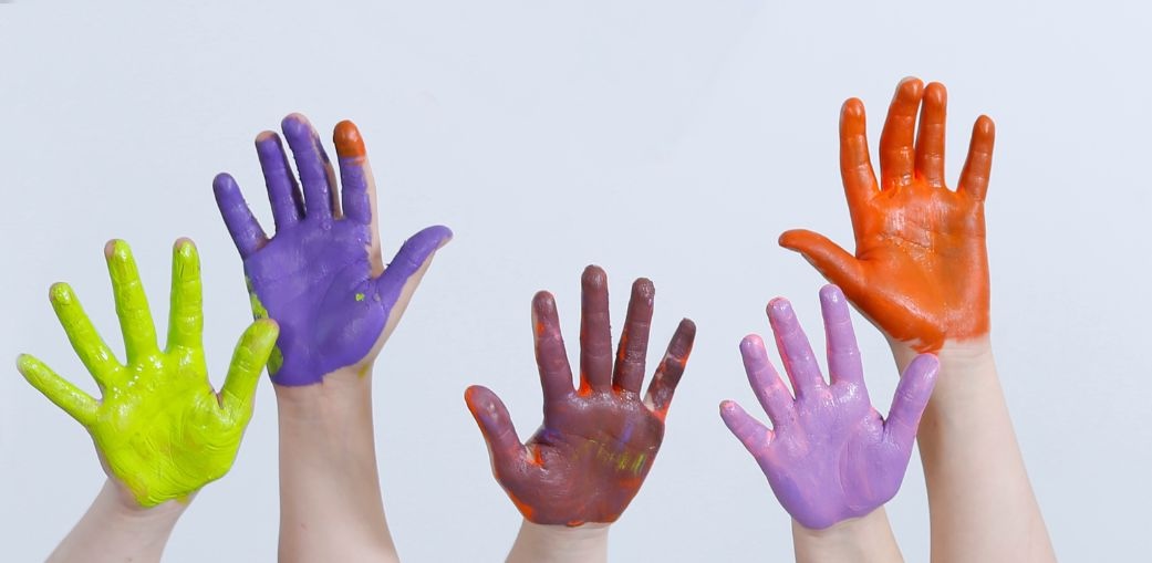 a group of children's hands painted in different colors