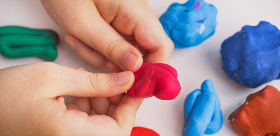 a close-up of hands holding a piece of clay