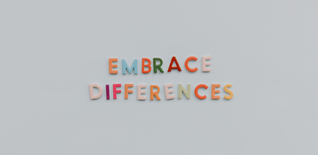 a close-up of colorful letters saying Embrace Differences representing the challenges and understanding of Autism
