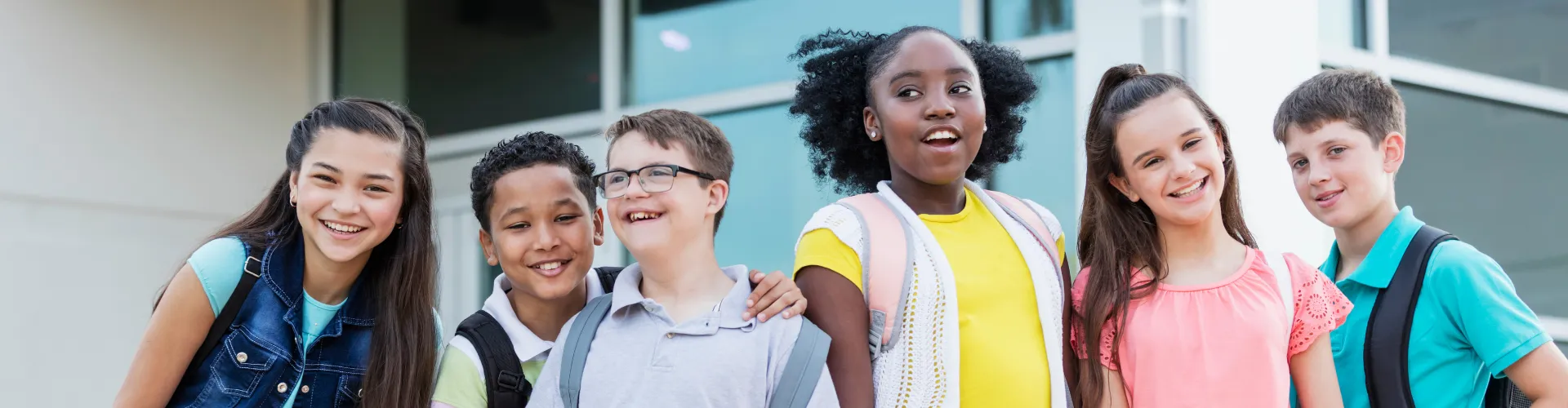 Middle age kids in front of a school